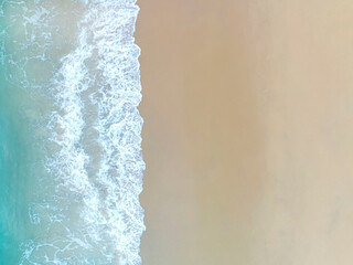 Top view of Soft waves with blue sea and sand  background on summer holidays