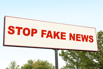 Advertising billboard with text STOP FAKE NEWS outdoors
