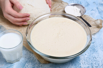 Raw batter in bowl on color background