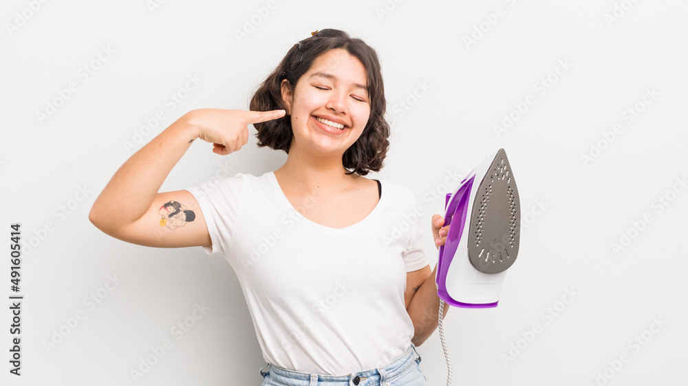 Wall mural pretty hispanic girl smiling confidently pointing to own broad smile. laundry concept