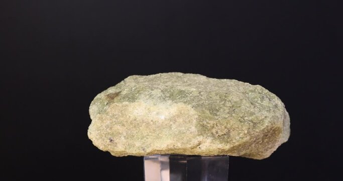 rotation of olivine mineral crystal on black background
