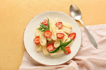 Plate of tasty lazy dumplings with strawberry on color background
