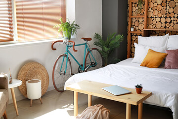 Stylish bicycle in interior of modern bedroom