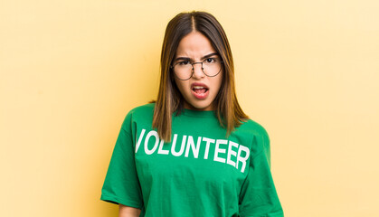 pretty hispanic girl feeling puzzled and confused. ecology concept