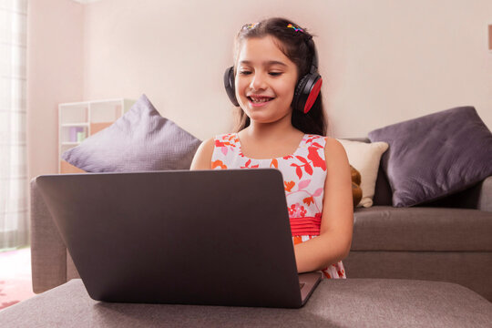 Girl studying online using laptop at home