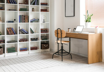 Interior of modern home library with workplace