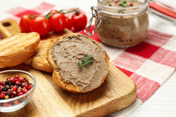 Fresh bread with delicious liver pate on white wooden table, closeup view