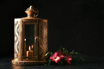 Muslim lantern and flowers on dark background