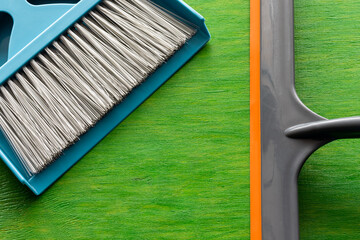 Accessories for cleaning and cleanliness on a bright green background. Cleaning works in the house...