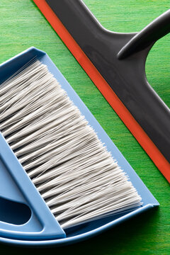 Vertical photo of a scoop and a broom for cleaning. Cleaning and cleanliness of the house.