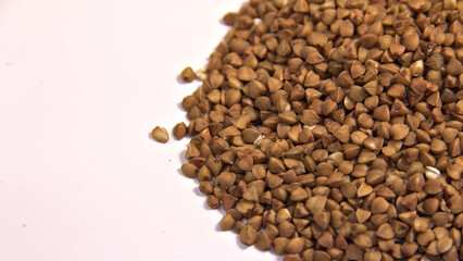 Sprinkled buckwheat on a white background. Close up.