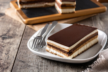 Opera cake dessert slice on wooden table