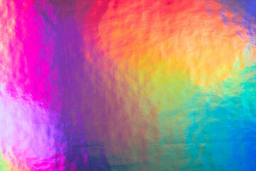 Iridescent holographic foil background. Bright vibrant colors backdrop. Trendy creative gradient.