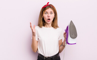 redhead pretty girl amazed, shocked and astonished with an unbelievable surprise. housekeeper...