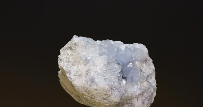 Macro close up celestine mineral gemstone on dark blue background