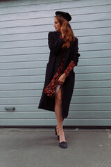 Portrait of a beautiful girl walking on the street in stylish clothes 