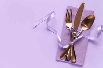 Simple table setting with flowers on purple background