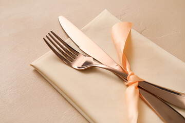 Simple table setting on beige background, closeup