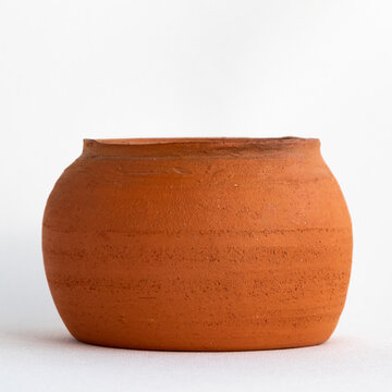 A clay pot of rounded shape.