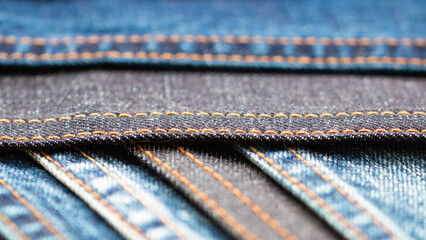 Detail of denim fabric and double stitched.  weathered denim fabric.. the selected focus point
