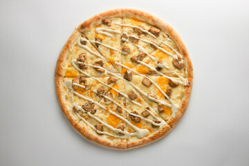 Pizza with chicken, mayonnaise sauce and cheese, on a white background