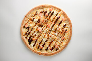 Pizza with red fish, cheese, teriyaki sauce, sesame and cheese on a white background