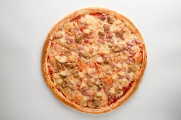 Pizza with pineapple, ham, meat and cheese on a white background