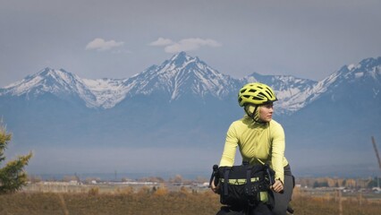 The woman travel on mixed terrain cycle touring with bikepacking. The traveler journey with bicycle...