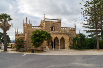 Fototapeta na wymiar The Gatehouse at the entrance too the Santa Maria Addolorata Cemetery also known as the Addolorata Cemetery which opened in 1869 - Paola, Malta.