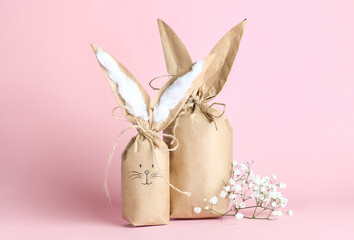 Paper bags bunny on color background