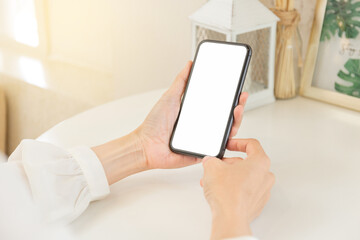 cell phone blank white screen mockup.hand holding texting using mobile on desk at office.background empty space for advertise.work people contact marketing business,technology