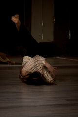 Photo of dancing long-haired blonde girl in torn jeans on brown background