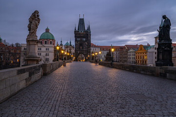 Dreamy night view. Early morning on the Charles Bridge in the Old Town of amazing historic city Prague, Czech Republic, Europe.