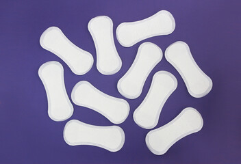 women's hygienic white daily pads on a purple background very peri