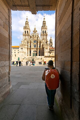 pilgrim woman in Obradoiro square looking the Santiago de Compostela cathedral after finishing the...