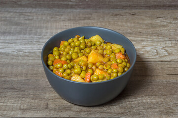 Fresh green peas with tomato sauce potatoes and carrot Greek food