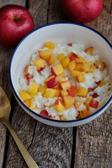 Rice pudding with apple. Side view, wooden background