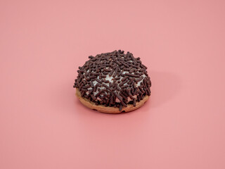 cake with chocolate chips on a pink background.