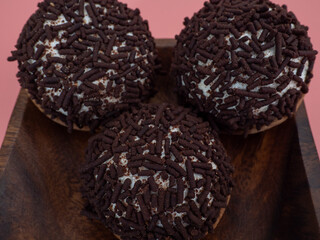 cake with chocolate chips on a pink background.