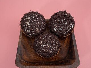 cake with chocolate chips on a pink background.