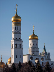 Fototapeta na wymiar Golden dome with orthodox cross close-up on a blue sky background