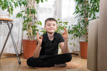 little kid boy practicing yoga, sitting in lotus position, indoor full length. Yogi kid on meditation and breathing session. Self isolation, keep calm. Kids sport home quarantine. Pranayama. Child hea