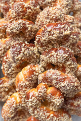 Stack of sweet pastry with honey and nuts. Romanian traditional pastry- mucenici, figure eight