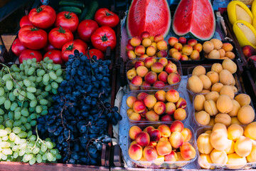 Naklejka na ściany i meble Fresh ripe fruits on the market in boxes