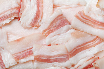 Slices of tasty salt pork as background, top view