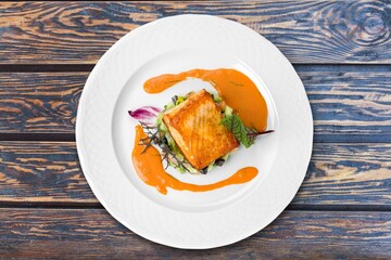 baked salmon steak with mustard, lemon, rosemary on a plate