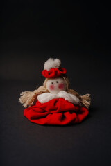 handmade cute red toy doll on black background. High quality photo