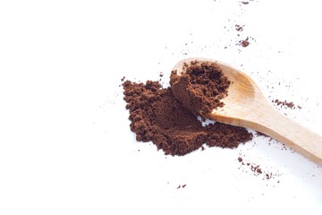 Top view coffee powder with wooden spoon isolated on white background.