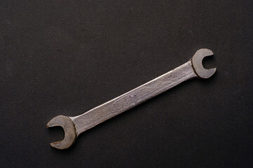 old metallic wrench in black background. High quality photo