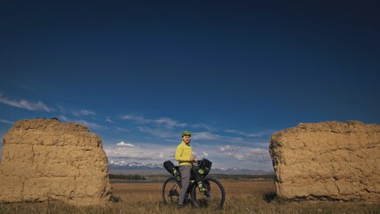 The man travel on mixed terrain cycle touring with bikepacking. The traveler journey with bicycle...